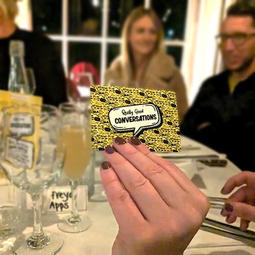 Friends playing Really Good Conversations at dinner